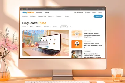 A RingCentral Pulse blog homepage displayed on a desktop monitor, featuring an article about RingCX's introduction of AI-powered workflows and enhanced analytics for effortless customer service operations.