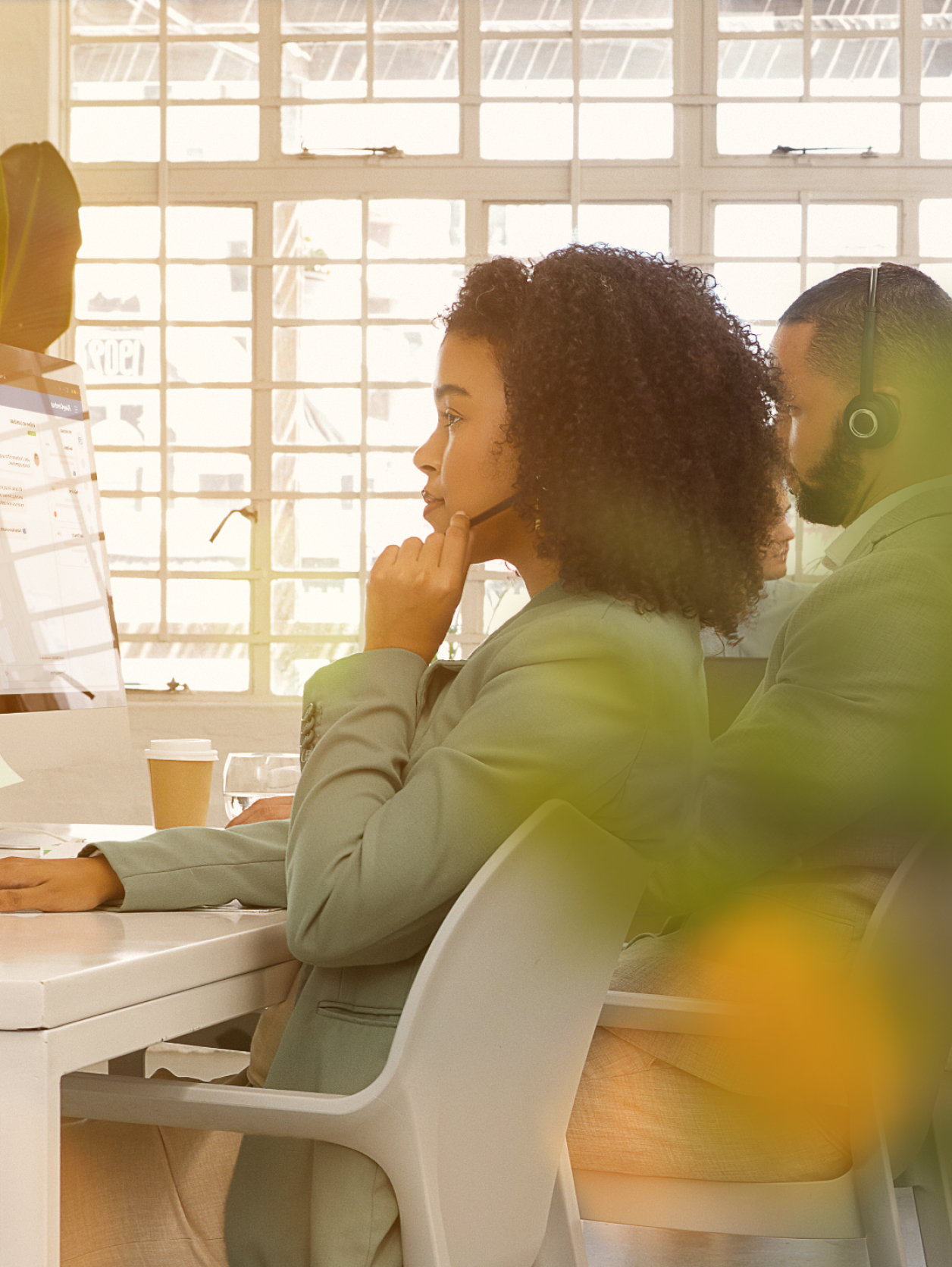 A sitting contact center agent in a conversation with a customer