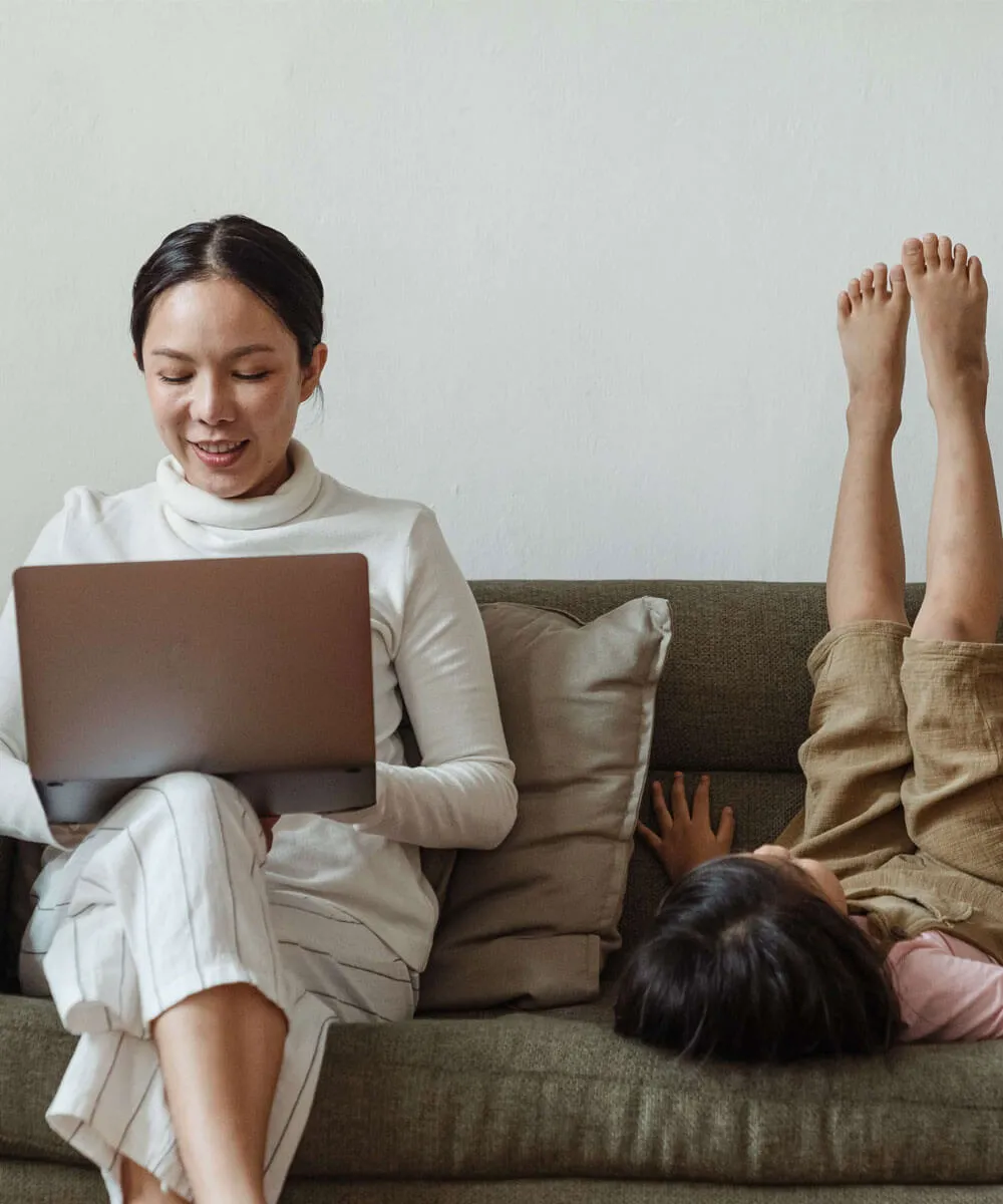 A work-from-home mom using RingCentral's virtual phone service from her laptop
