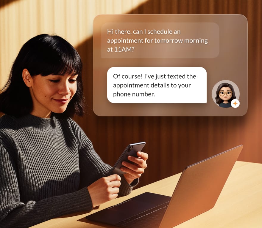 A woman on a conversation with RingAI receptionist on her mobile phone in front of a laptop