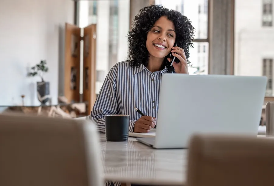 Employee taking phone calls from her home office